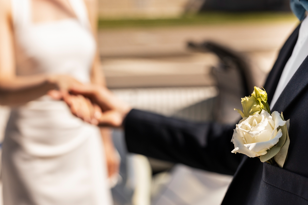 Sightly out of focus image of bride and groom holding hands